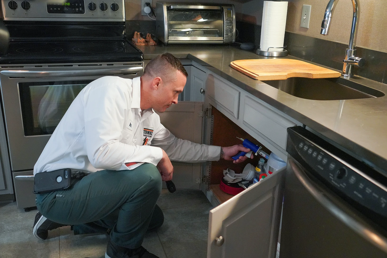 tech inspecting kitchen for pest