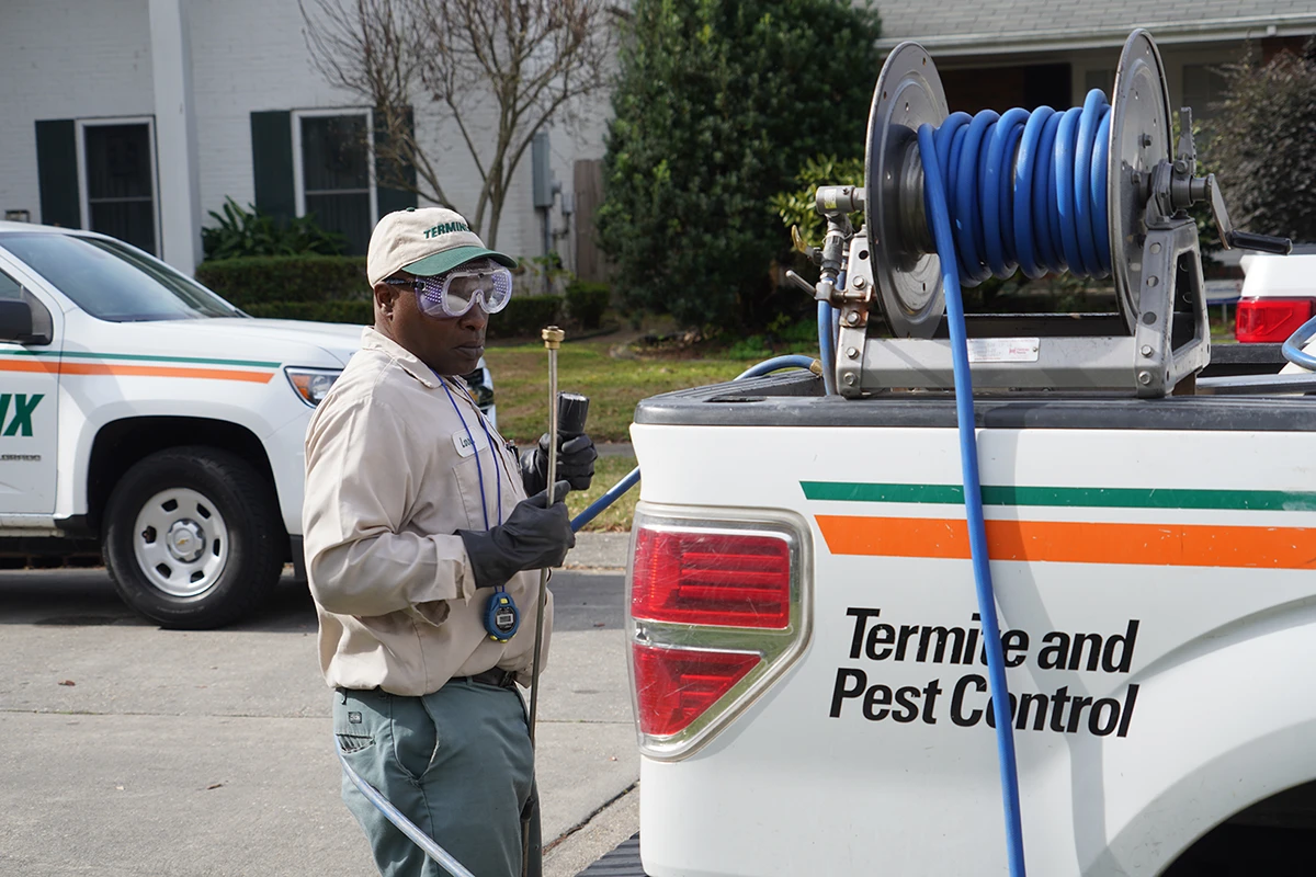 Terminix Nola tech next to truck with pest supplies