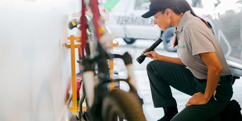 Terminix tech inspecting garage in home