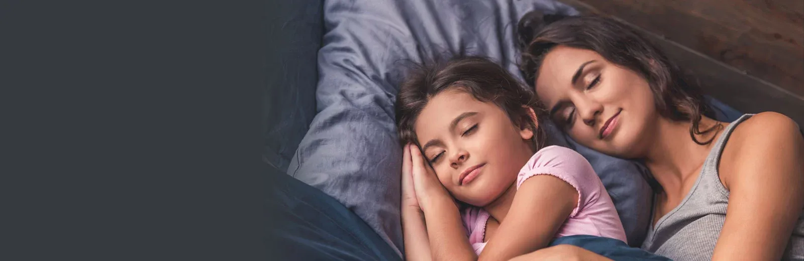 Mother and daughter sleeping peacefully in bed bug free bed